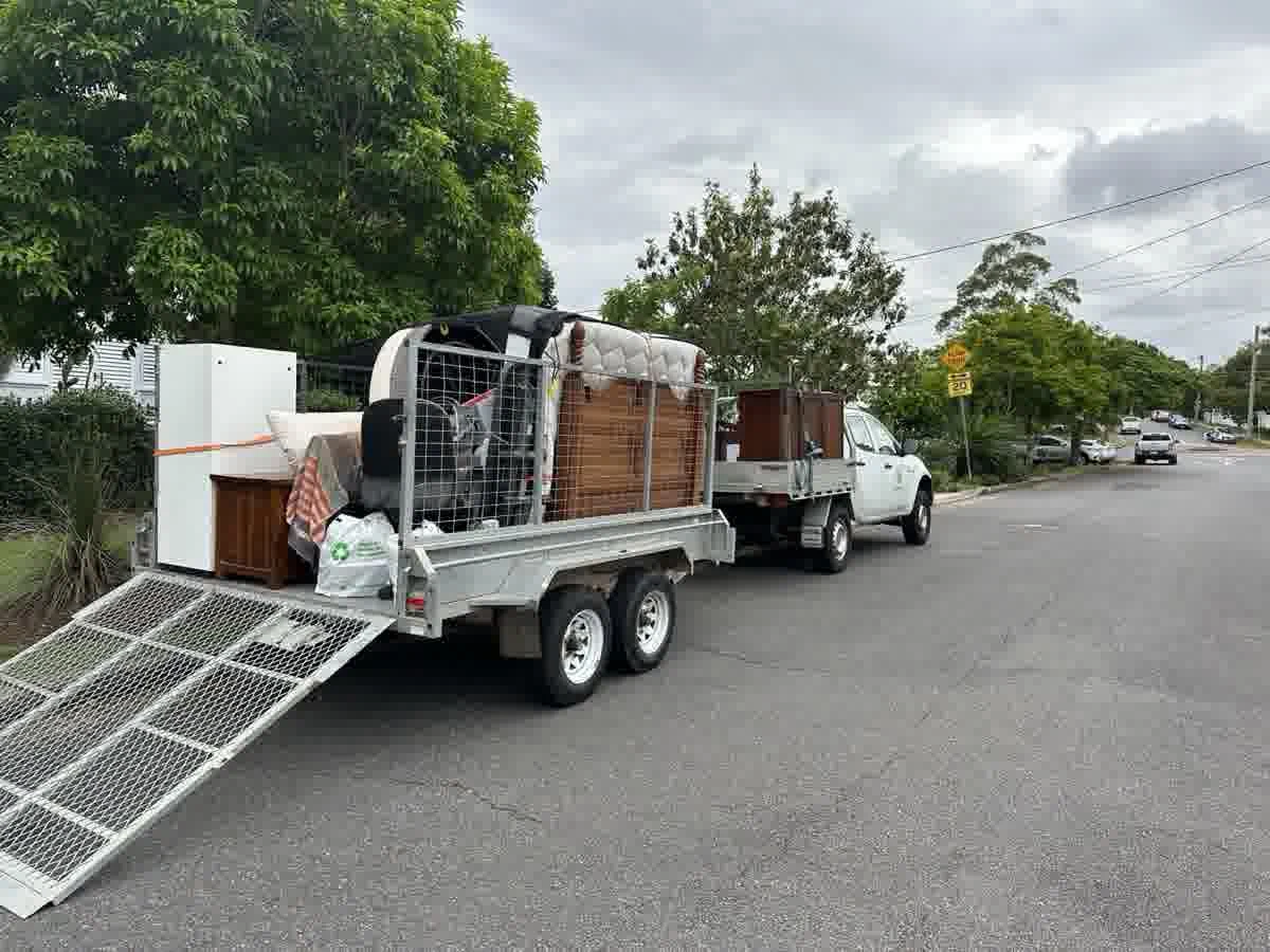 Trailer loaded with household rubbish on a Brisbane street
