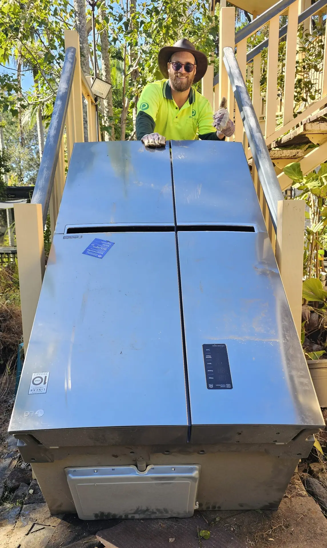 Fridge being removed from stairs.